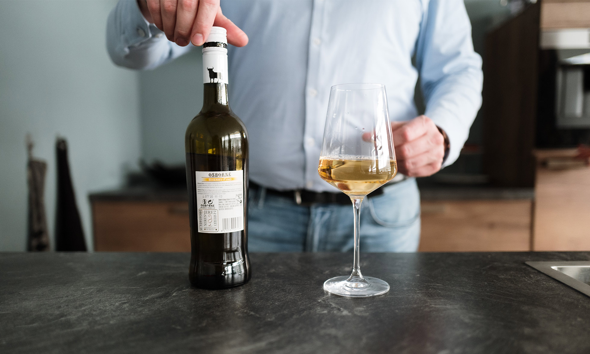 Bottle of wine next to a half-full wine glass