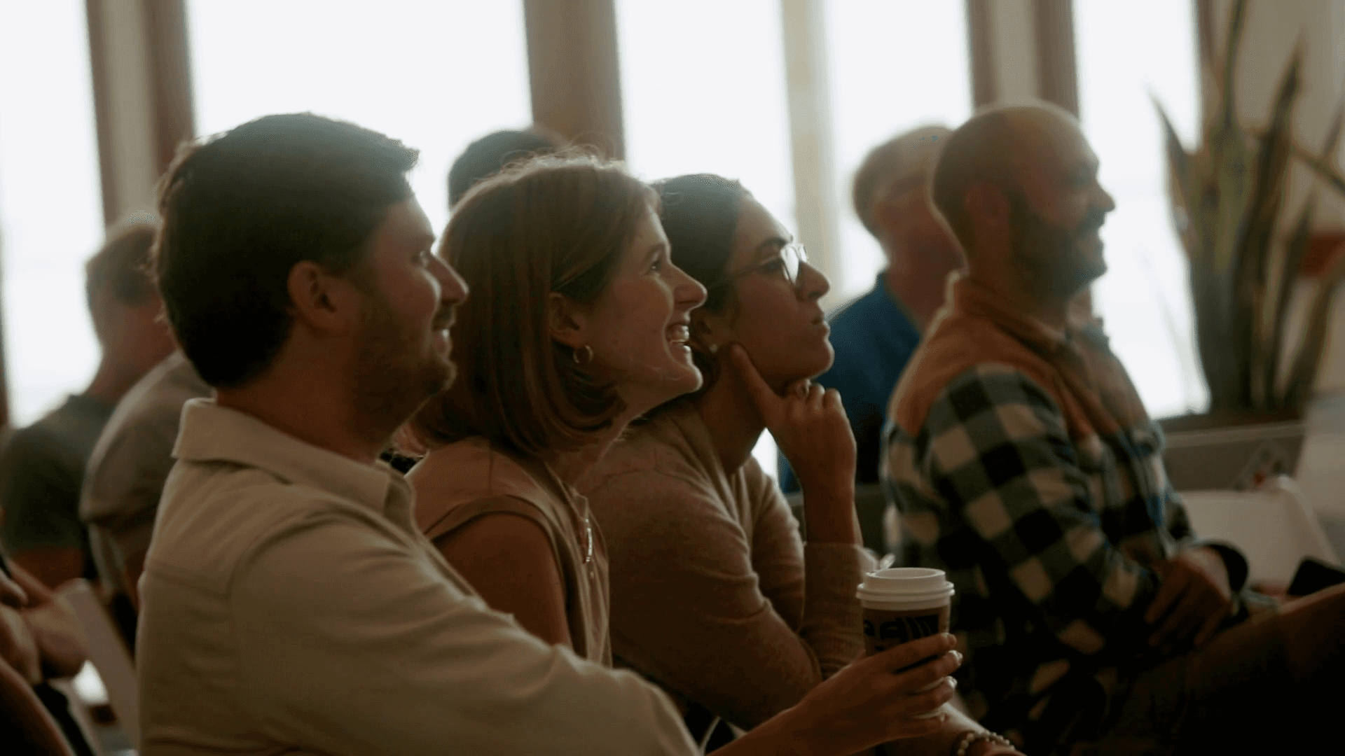 An audience listening to a speaker session.