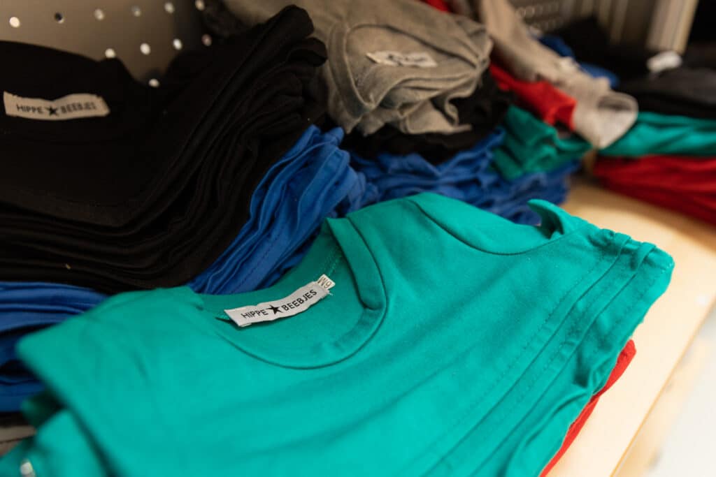 Folded turquoise top with a Hippe Beebjes tag.