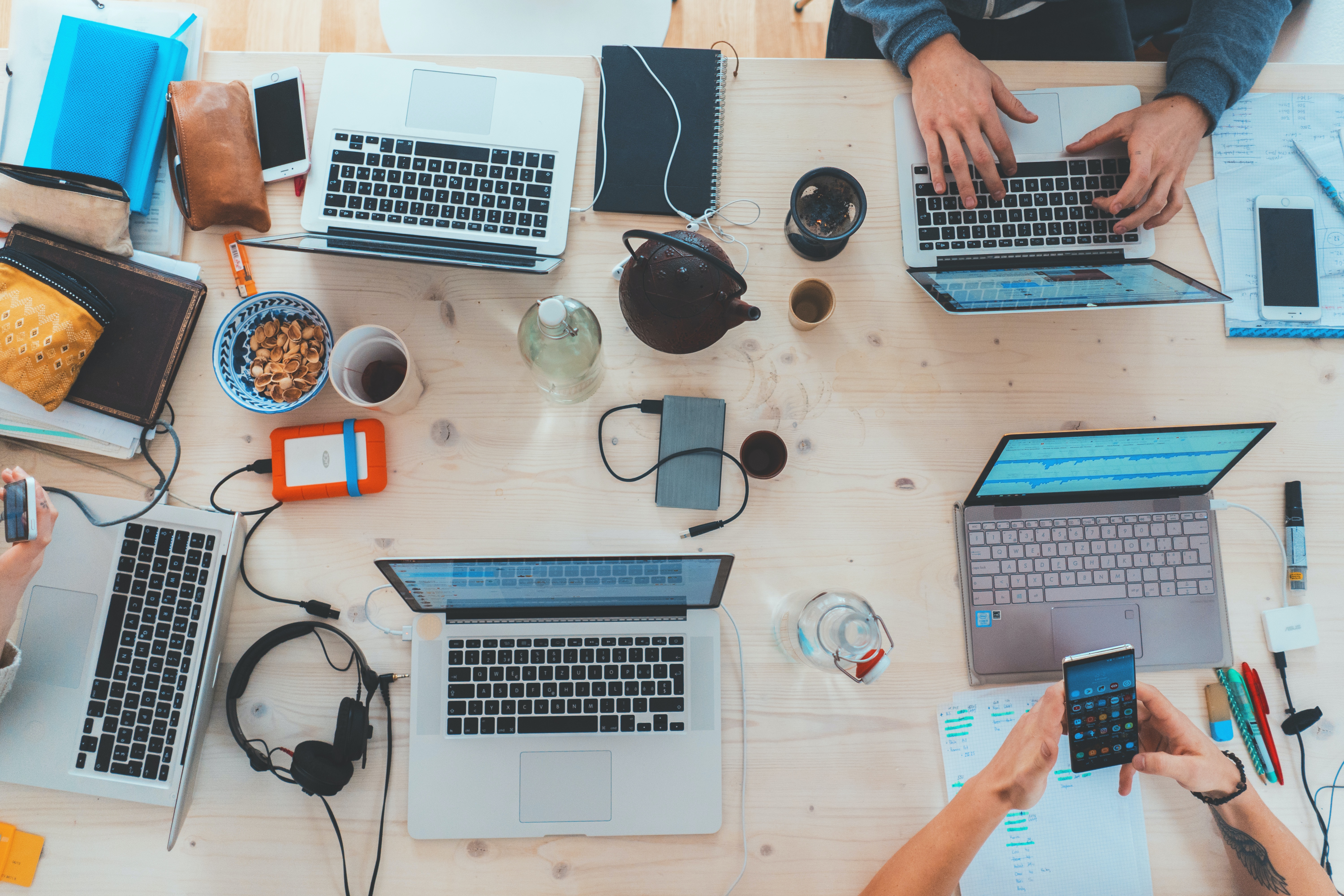 multiple people using computers on a desk